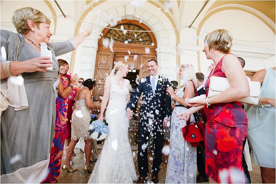confetti bring thrown over the bride and groom in lake garda