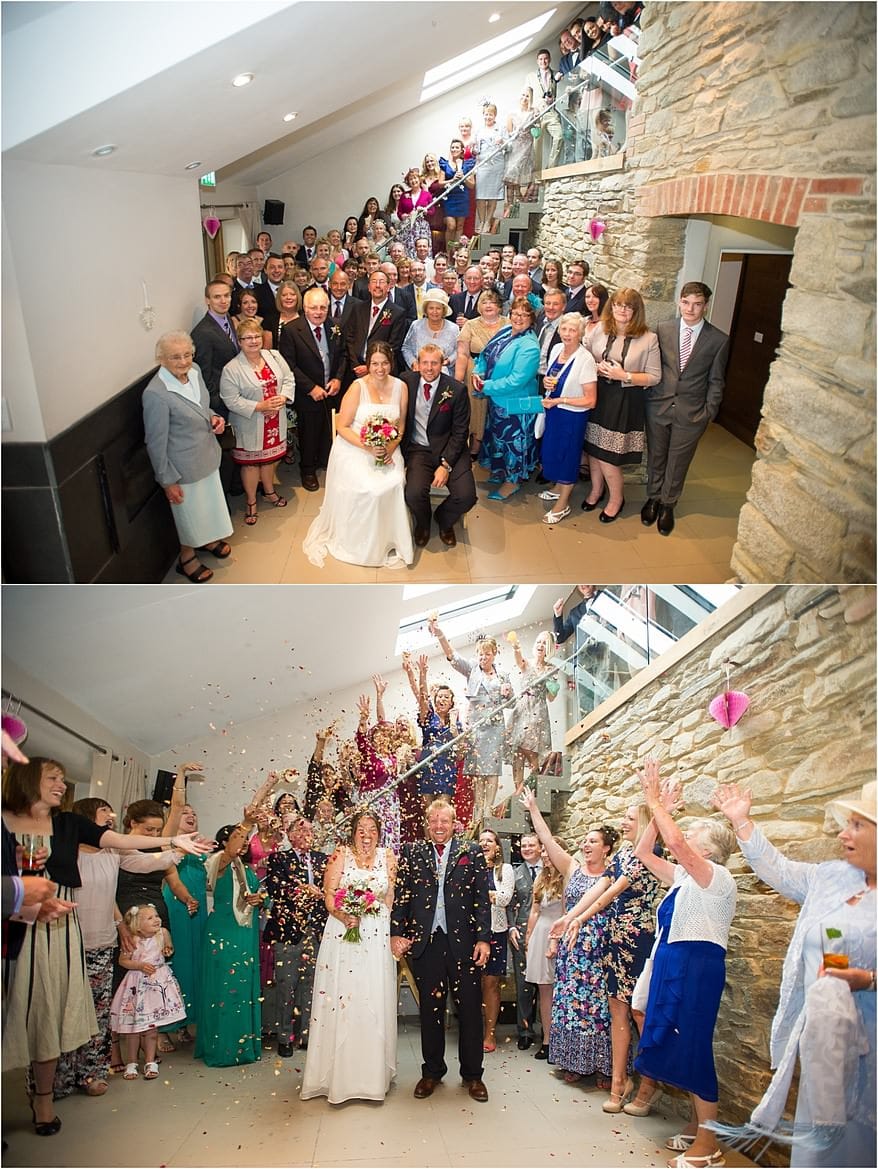 group photograph of the wedding guests inside the barn of trevenna