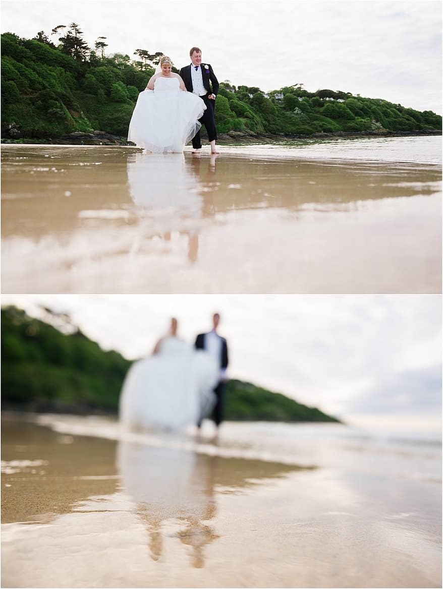 Bride and groom paddling in the sea at Carbis Bay Hotel's Beach